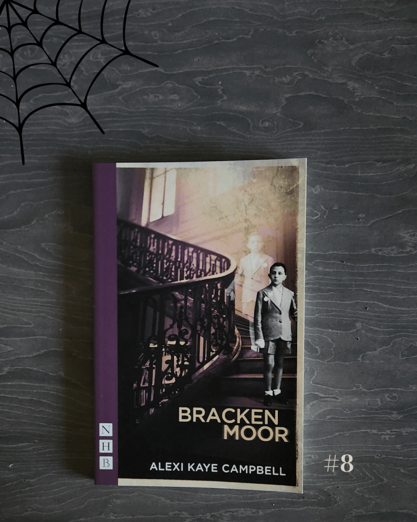 A flat lay of the play Bracken Moor by Alexi Kaye Campbell, published by Nick Hern Books (NHB). The book cover shows a sepia-toned photograph of a staircase with a young boy standing on the steps, accompanied by a faint ghostly figure behind him. The cover has a purple spine and gold text. A black spider web graphic decorates the top left corner, and the number “#8” appears in light gray at the bottom right, tying into a Halloween or spooky theme.